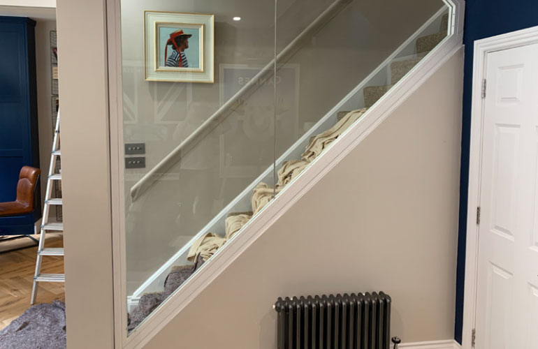 Glass balustrade fitted to a domestic staircase in place of timber spindles